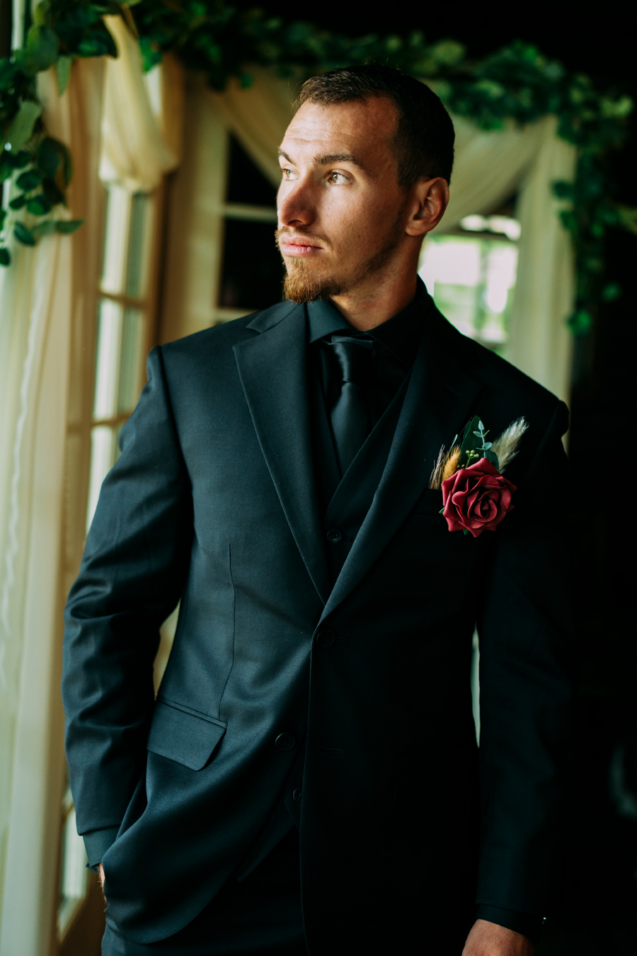 Groom looking out the window before wedding at Ever After Farms Ranch